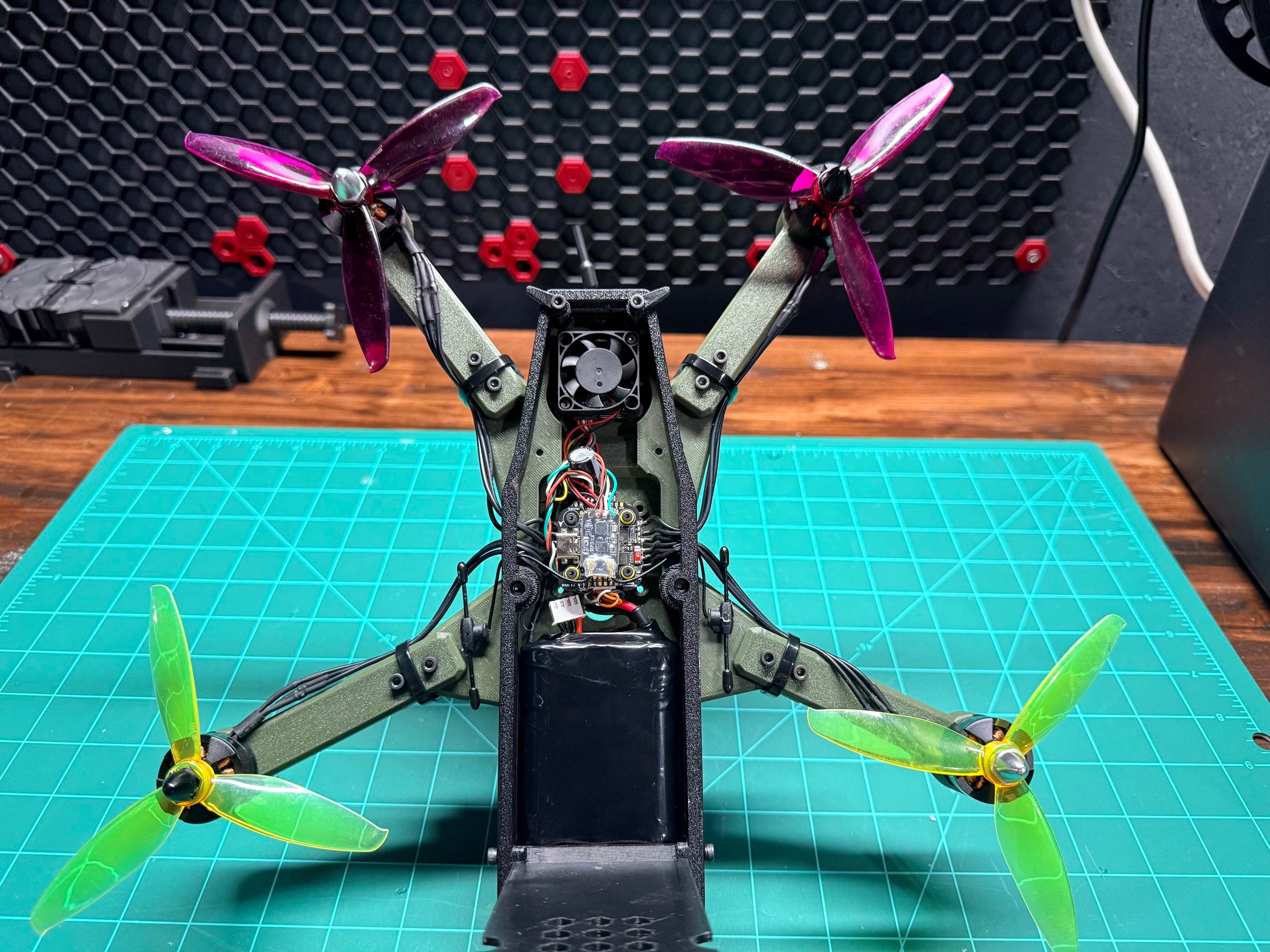 ADAMAAS Nomad with top cover open showing cooling fan, flight stack, and Li-ion battery